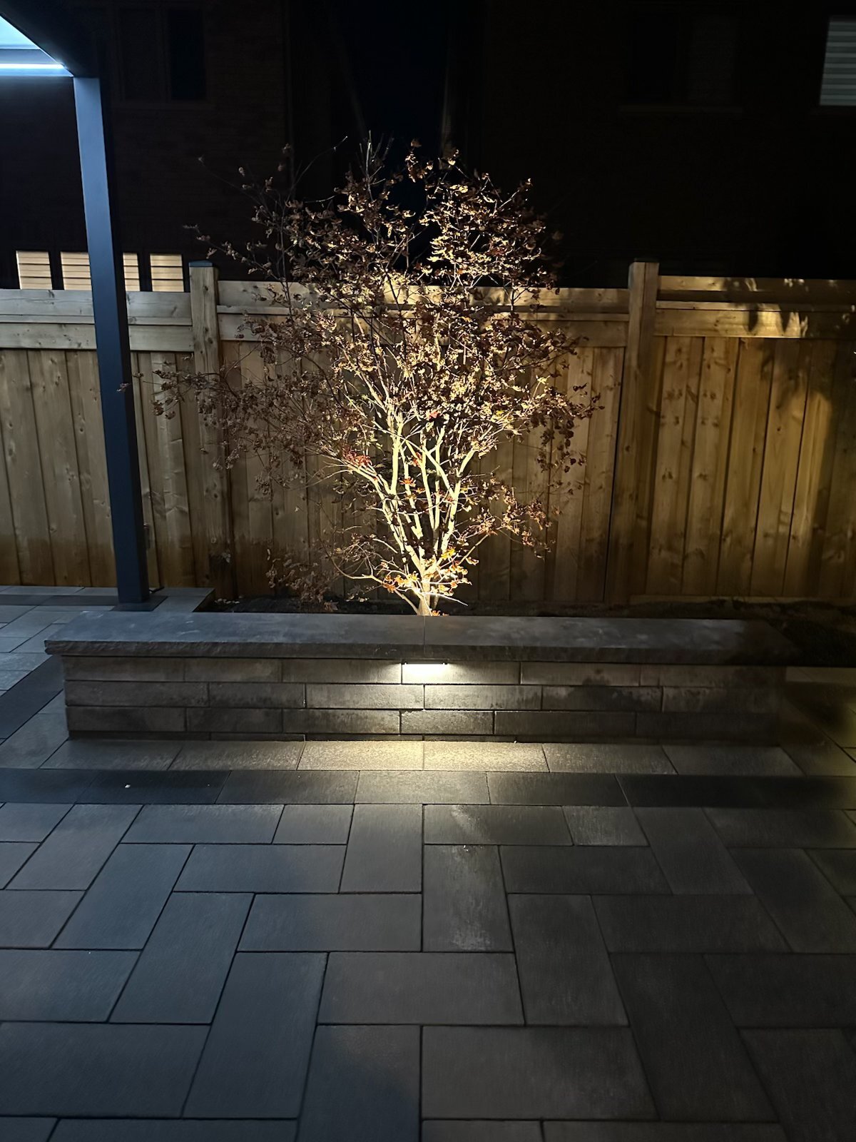Modern stone planter bench at night