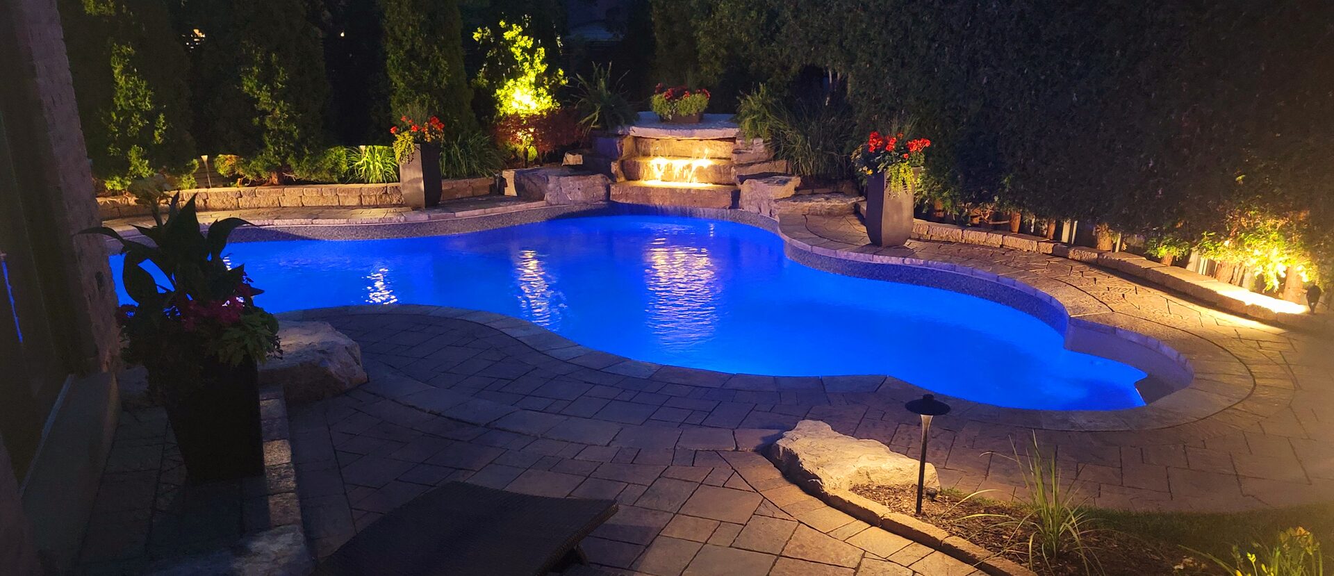 Pool with stone waterfall feature